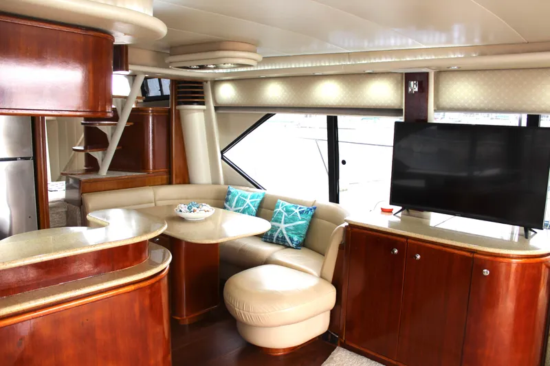 Our Time Yacht Photos Pics Luxurious interior of 2001 Bayliner 5788 Pilot House Motoryacht with modern furnishings and large TV.