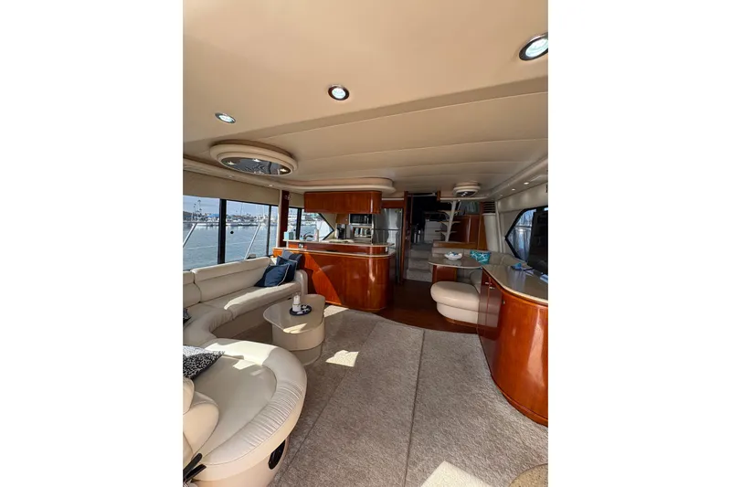 Our Time Yacht Photos Pics Luxurious interior of 2001 Bayliner 5788 Pilot House Motoryacht with elegant seating and wood finishes.