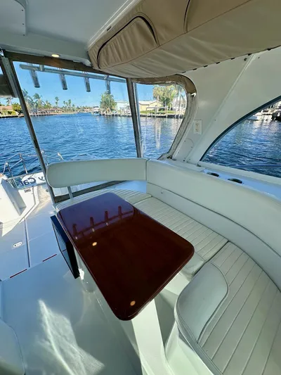 Sassy Cat Yacht Photos Pics Interior of 2009 Glacier Bay 3080 boat with seating and table, overlooking water.