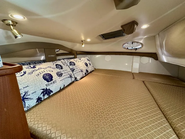 Sassy Cat Yacht Photos Pics Cozy cabin interior of 2009 Glacier Bay 3080 with patterned bedding and ambient lighting.