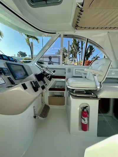 Sassy Cat Yacht Photos Pics 2009 Glacier Bay 3080 boat cockpit with steering wheel, control panel, and captain's chair.