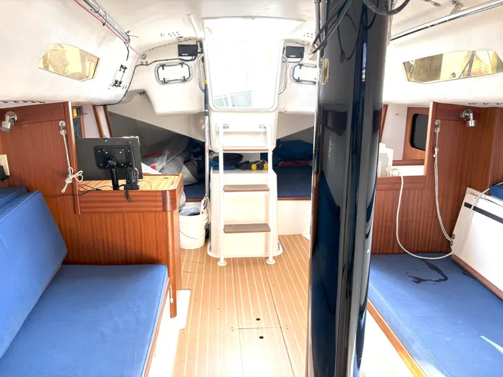 Ripple Yacht Photos Pics Interior of 2015 J Boats J 111 sailboat with blue seating and wooden accents.