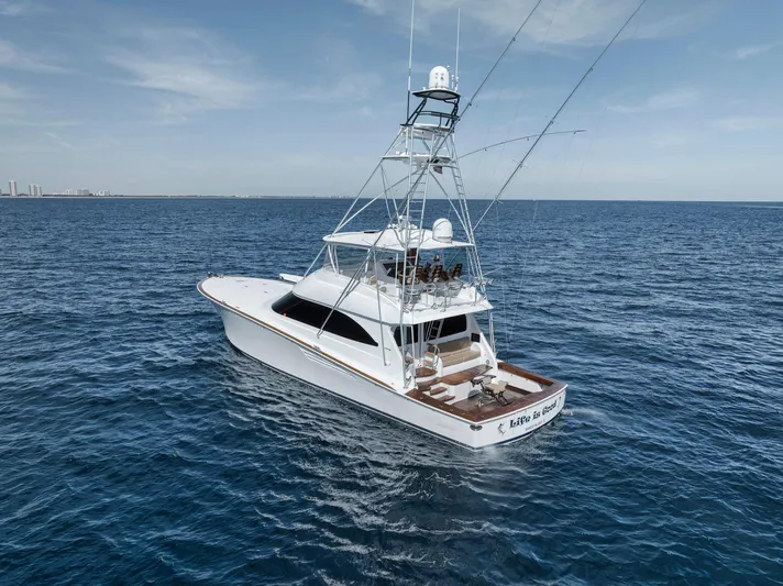 Life Is Good Yacht Photos Pics 2015 Viking 70 Convertible yacht cruising on open sea under clear skies.