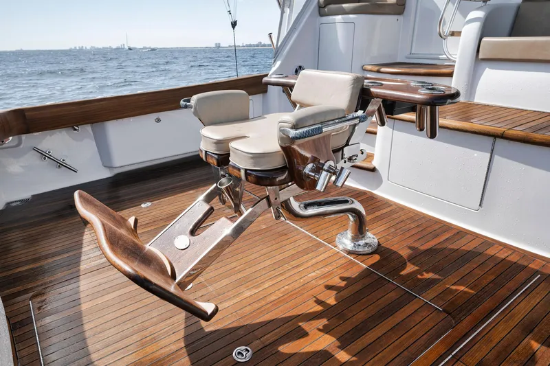 Life Is Good Yacht Photos Pics Viking 70 Convertible 2015 yacht deck with fishing chair, wooden flooring, and ocean view.