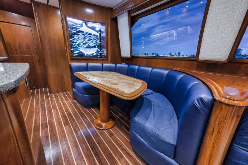 Life Is Good Yacht Photos Pics Luxurious interior of 2015 Viking 70 Convertible yacht with blue seating and wooden accents.
