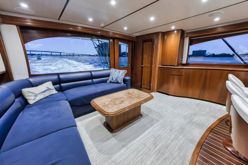 Life Is Good Yacht Photos Pics Luxurious interior of 2015 Viking 70 Convertible yacht with blue seating and wooden accents.