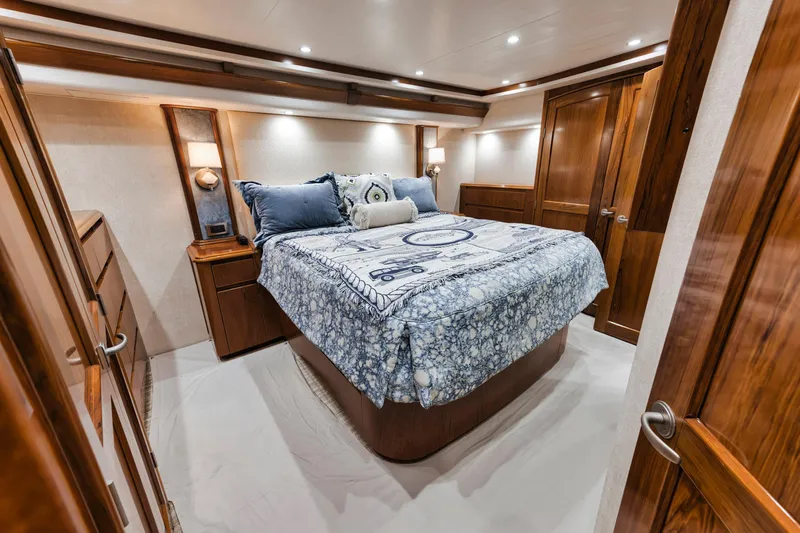 Life Is Good Yacht Photos Pics Luxurious bedroom interior of 2015 Viking 70 Convertible yacht with elegant wood finishes.