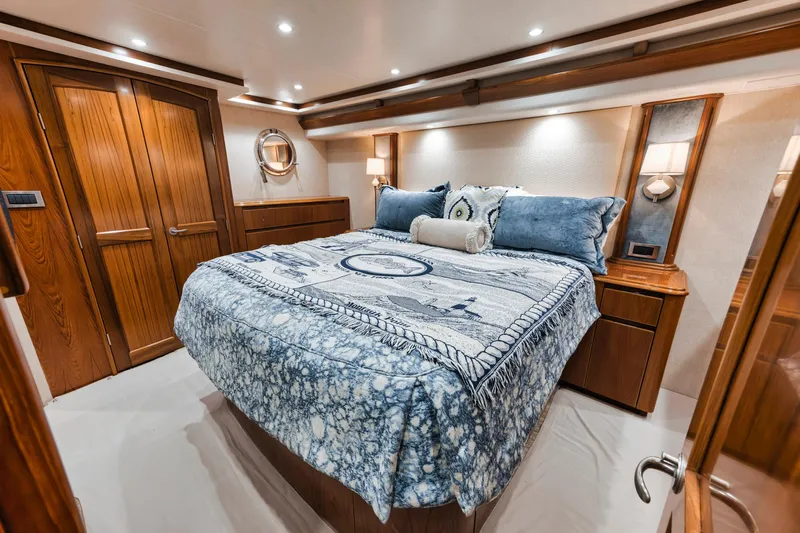 Life Is Good Yacht Photos Pics Luxurious bedroom interior of 2015 Viking 70 Convertible yacht with elegant wood finishes.