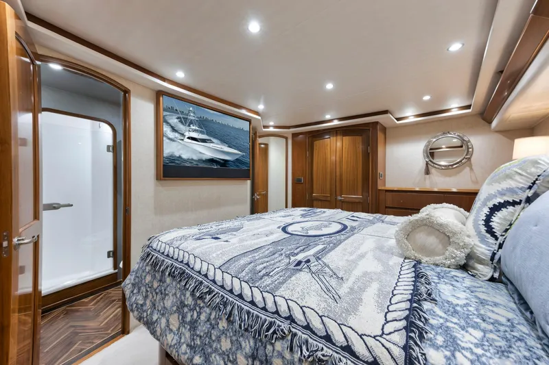 Life Is Good Yacht Photos Pics Luxurious bedroom interior of 2015 Viking 70 Convertible yacht with elegant decor and wood finishes.