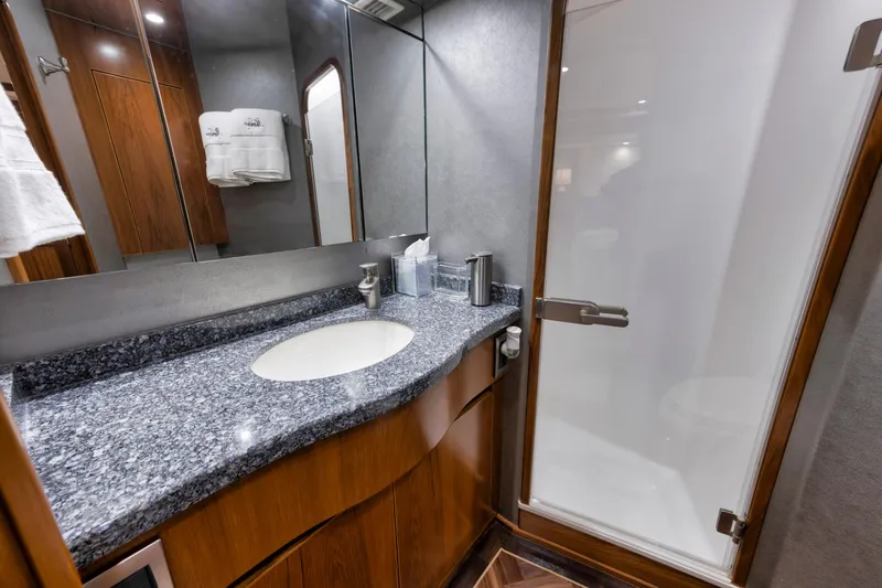 Life Is Good Yacht Photos Pics Luxurious bathroom in 2015 Viking 70 Convertible yacht with granite countertop and glass shower.