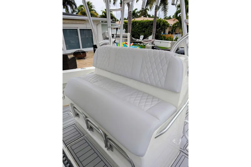 Hazard Pay Yacht Photos Pics 2017 SeaVee 390Z boat with white cushioned seating and diamond stitching.