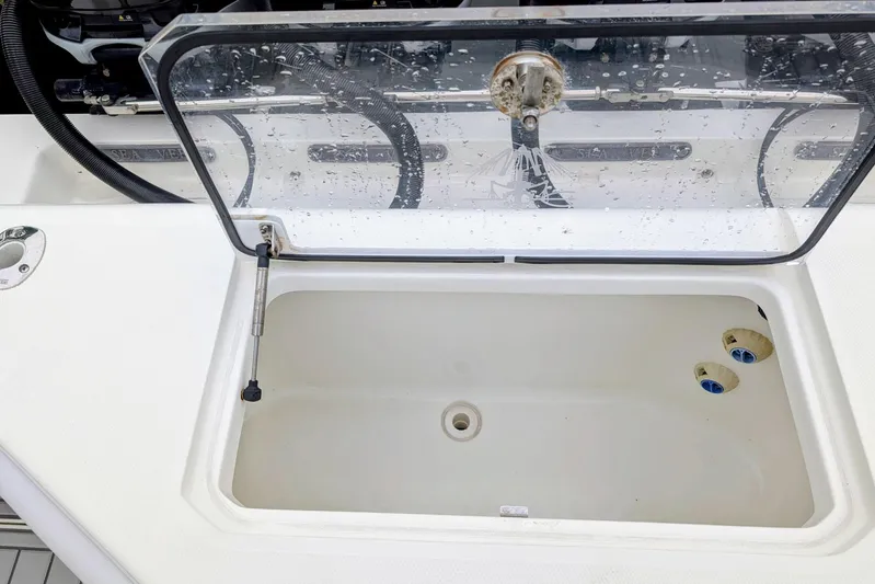 Hazard Pay Yacht Photos Pics Open storage compartment on 2017 SeaVee 390Z boat, featuring a clear lid and drainage holes.