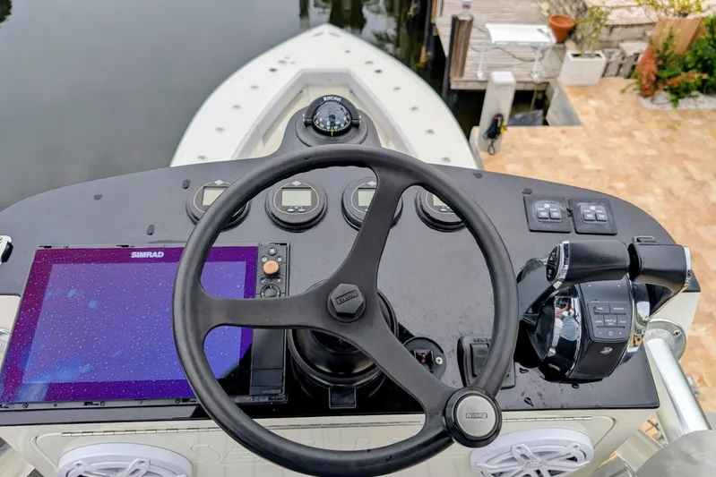 Hazard Pay Yacht Photos Pics 2017 SeaVee 390Z boat helm with steering wheel, Simrad display, and controls.