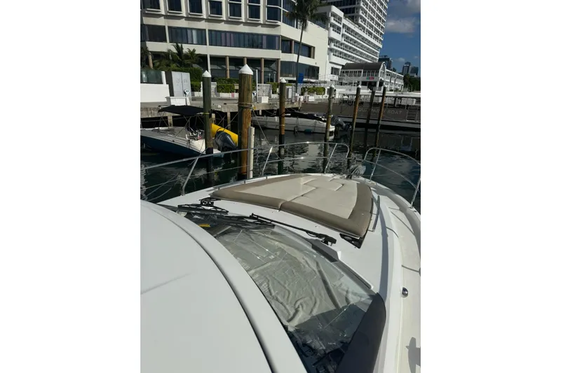 Lololand Yacht Photos Pics 2018 Jeanneau Leader 36 yacht docked at a marina with cityscape background.