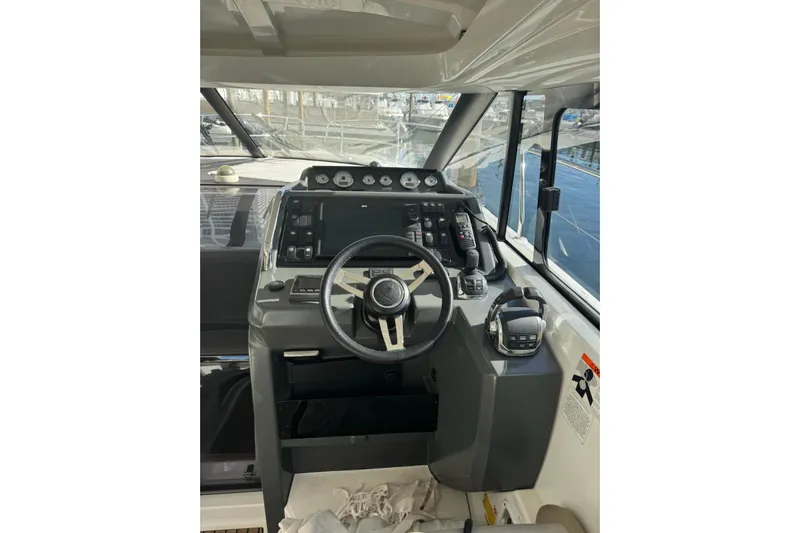 Lololand Yacht Photos Pics Helm of 2018 Jeanneau Leader 36 boat with steering wheel and control panel.