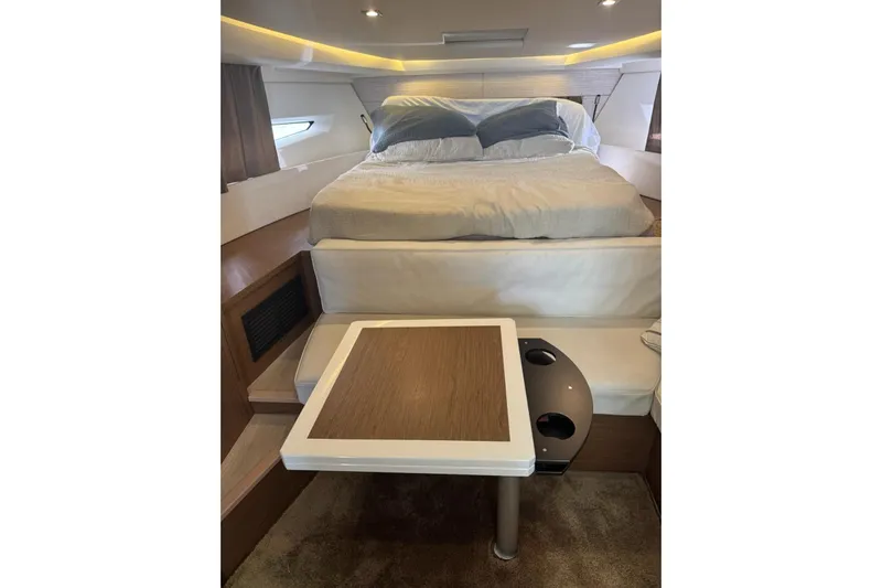Lololand Yacht Photos Pics Luxurious interior of 2018 Jeanneau Leader 36 yacht with cozy bed and table.