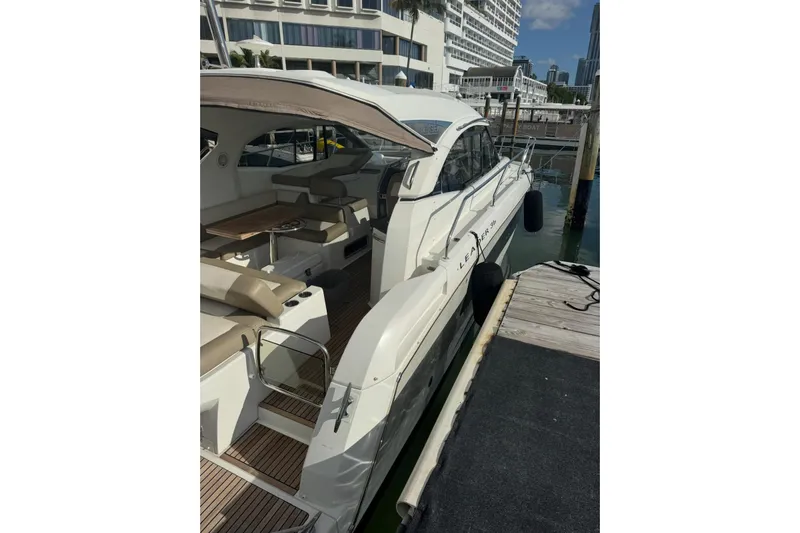 Lololand Yacht Photos Pics 2018 Jeanneau Leader 36 yacht docked, featuring spacious seating and sleek design.