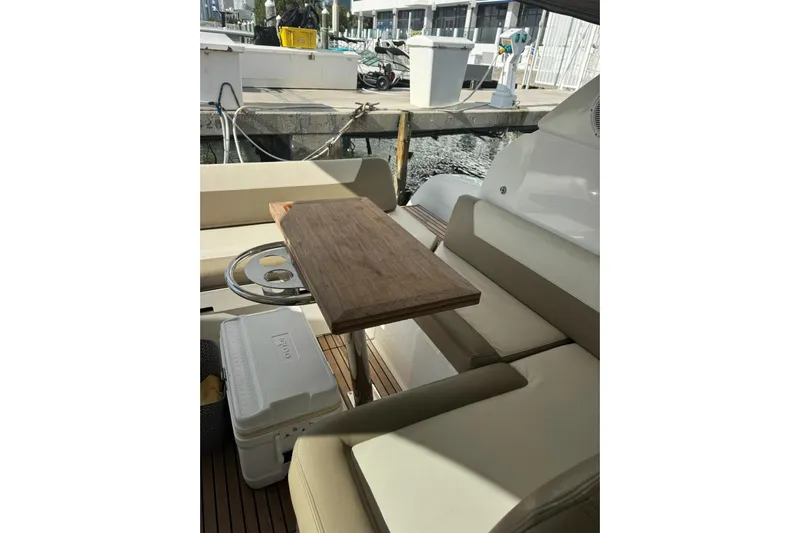 Lololand Yacht Photos Pics 2018 Jeanneau Leader 36 yacht interior with seating and wooden table.
