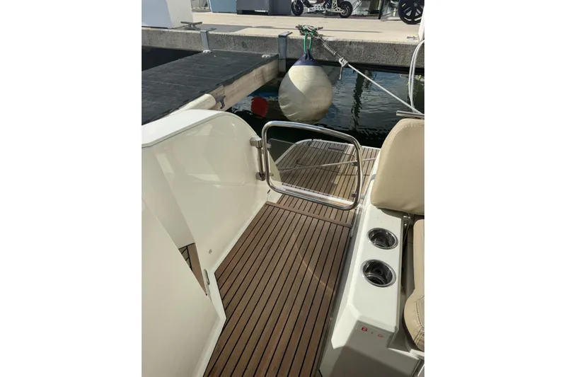 Lololand Yacht Photos Pics 2018 Jeanneau Leader 36 boat deck with wooden flooring and dock view.