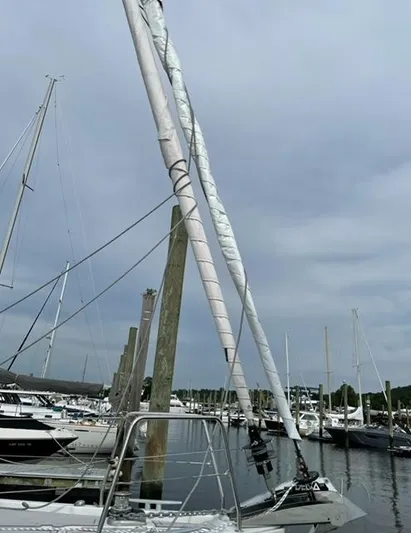  Yacht Photos Pics 2018 Beneteau Oceanis 41.1 sailboat docked in a marina under cloudy skies.