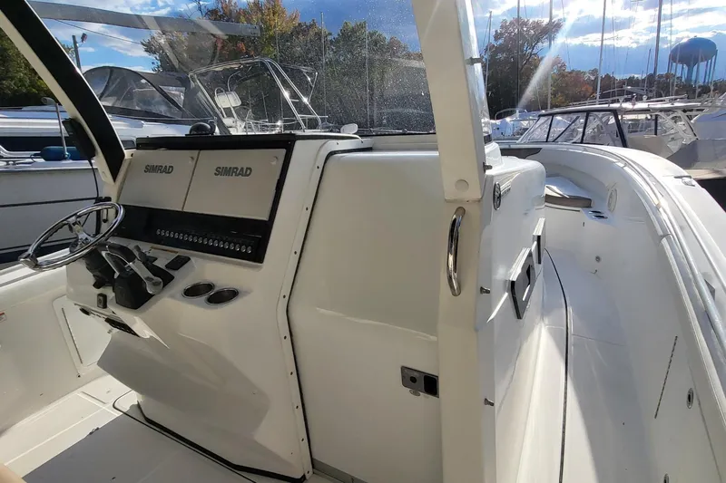  Yacht Photos Pics 2018 Edgewater 370CC boat cockpit with Simrad navigation system and steering wheel.