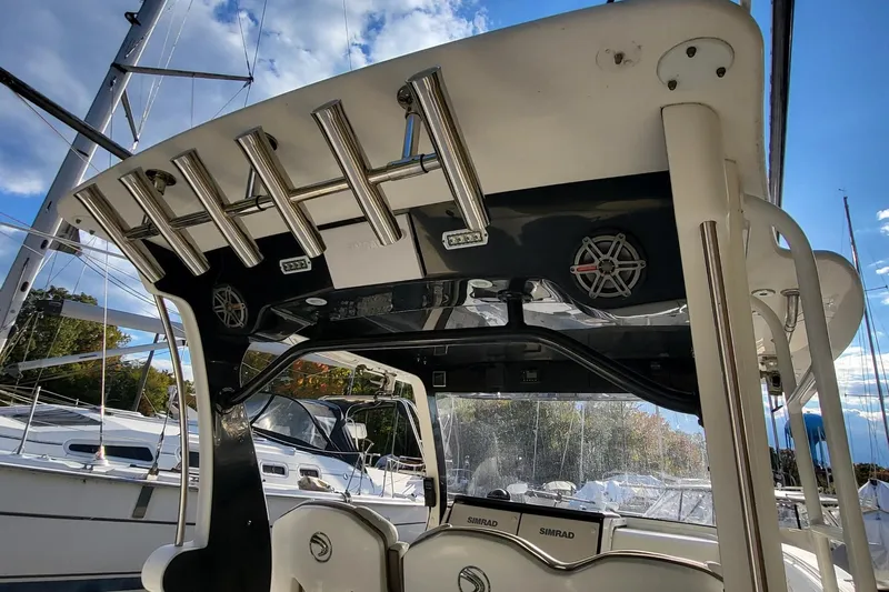  Yacht Photos Pics 2018 Edgewater 370CC boat interior with rod holders and speakers, docked near sailboats.