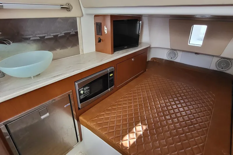  Yacht Photos Pics 2018 Edgewater 370CC cabin interior with bed, microwave, TV, and modern amenities.