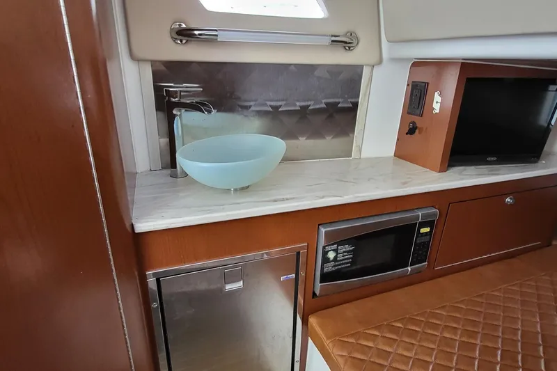  Yacht Photos Pics 2018 Edgewater 370CC interior with sink, microwave, and seating area.