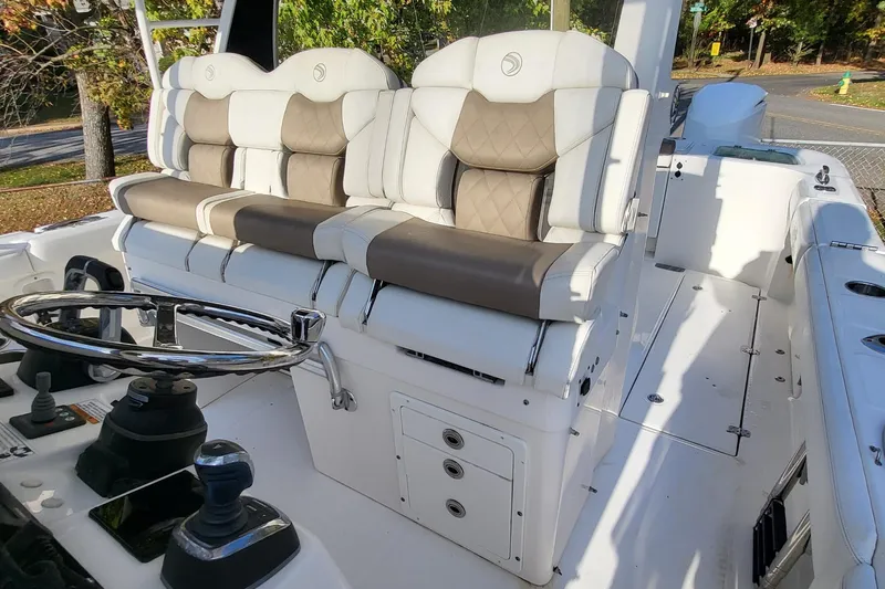  Yacht Photos Pics 2018 Edgewater 370CC boat interior with dual cushioned seats and steering wheel.