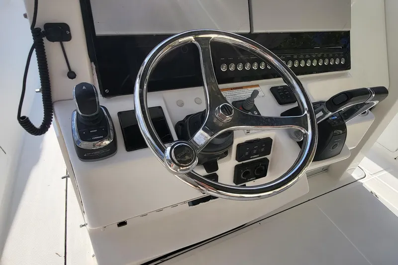  Yacht Photos Pics Steering console of 2018 Edgewater 370CC boat with controls and chrome wheel.