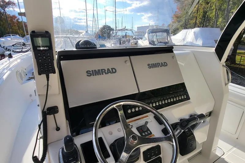  Yacht Photos Pics 2018 Edgewater 370CC boat helm with Simrad electronics and steering wheel.