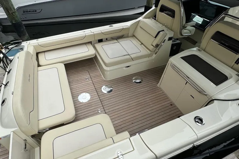  Yacht Photos Pics 2022 Chris-Craft Calypso 35 boat interior with beige seating and wooden deck.