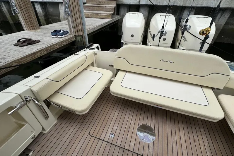  Yacht Photos Pics 2022 Chris-Craft Calypso 35 boat interior with seating and outboard motors at dock.