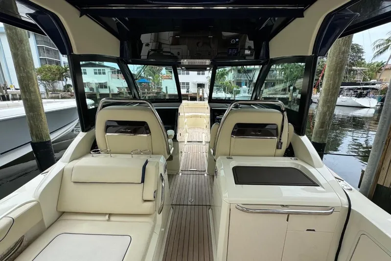  Yacht Photos Pics 2022 Chris-Craft Calypso 35 interior with luxurious seating and sleek design at a marina.