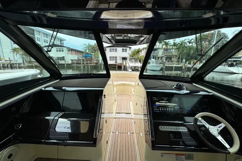  Yacht Photos Pics 2022 Chris-Craft Calypso 35 boat interior with modern dashboard and waterfront view.