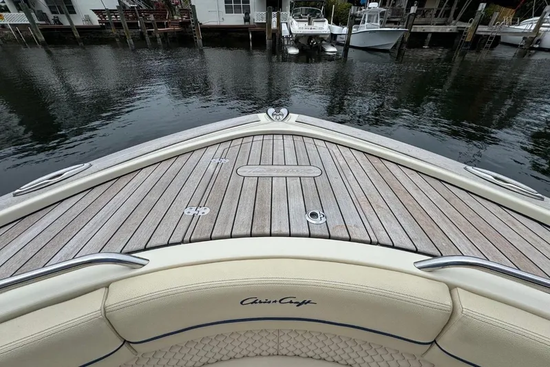  Yacht Photos Pics 2022 Chris-Craft Calypso 35 boat with teak deck, docked by waterfront homes.
