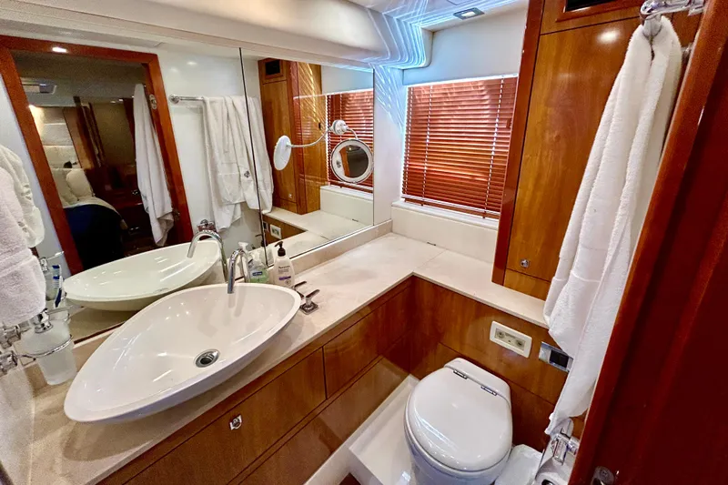 Casa Sul Mare Yacht Photos Pics Luxurious bathroom in 2010 Sunseeker Predator 64 yacht with modern fixtures and wooden accents.