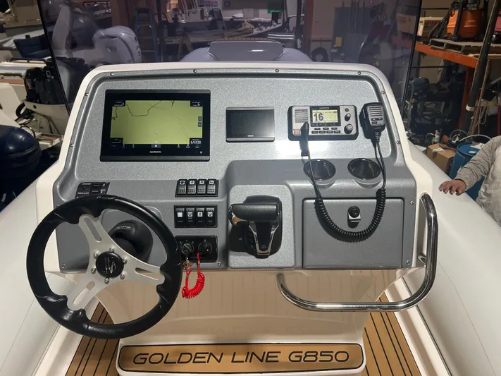  Yacht Photos Pics 2024 Grand Goldenline 850 boat dashboard with steering wheel and navigation controls.
