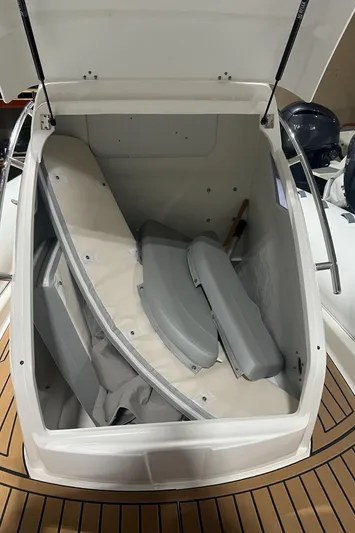  Yacht Photos Pics 2024 Grand Goldenline 850 boat storage compartment with cushions and accessories.