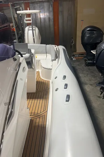  Yacht Photos Pics 2024 Grand Goldenline 850 boat with sleek design and wooden deck.