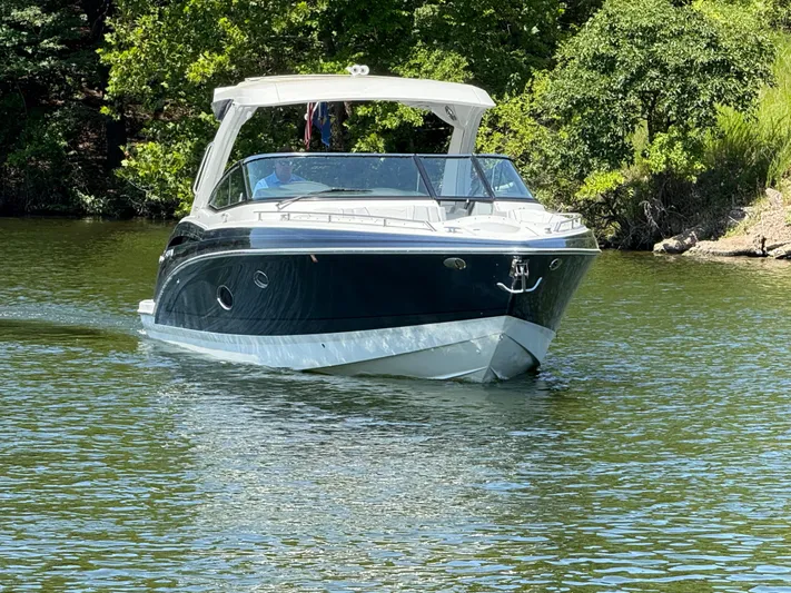  Yacht Photos Pics 2023 Formula 350 Crossover Bowrider I/O cruising on a serene lake.