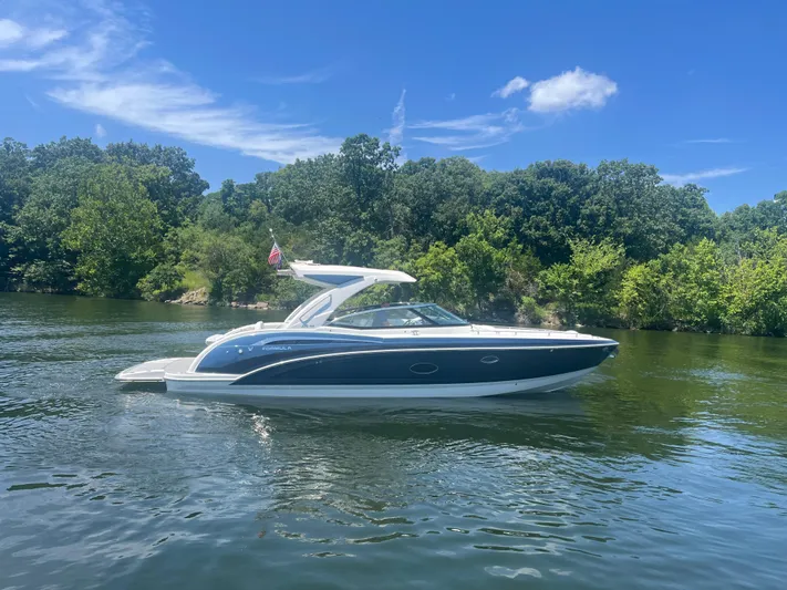  Yacht Photos Pics 2023 Formula 350 Crossover Bowrider I/O on a scenic lake with lush greenery.