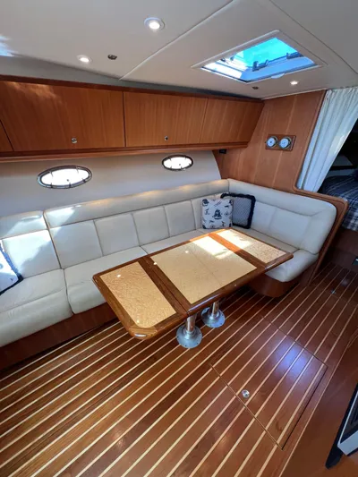 Audacious Yacht Photos Pics 2008 Tiara Yachts 4200 Open interior with elegant seating and wooden flooring.