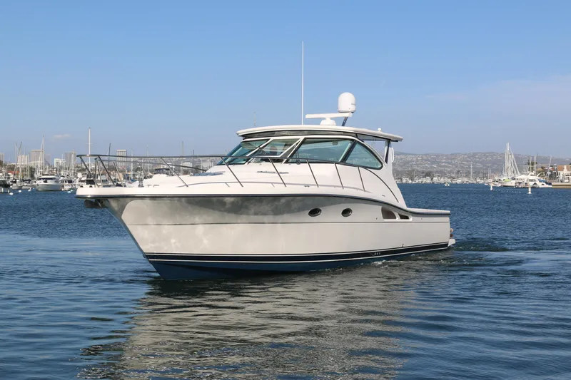 Audacious Yacht Photos Pics 2008 Tiara Yachts 4200 Open cruising in a marina under clear blue skies.