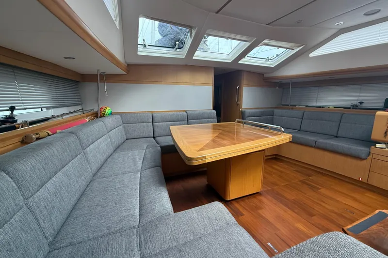 Tashatoo III Yacht Photos Pics Luxurious interior of 2013 Gunfleet 58 yacht with spacious seating and wooden table.