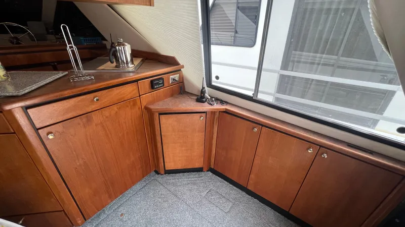  Yacht Photos Pics Interior of 1999 Bayliner 3988 Motoryacht with wooden cabinets and countertop.