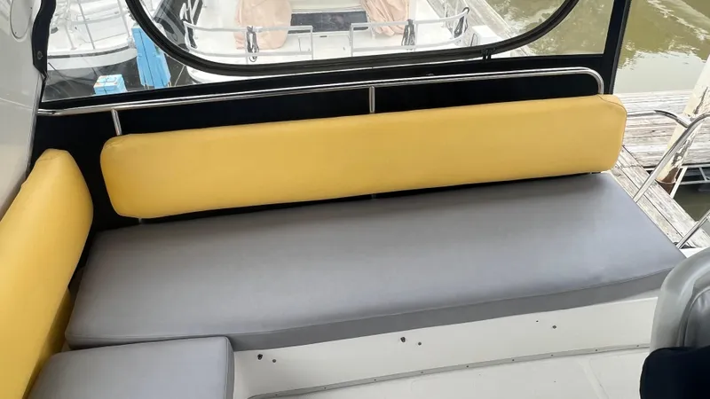  Yacht Photos Pics 1999 Bayliner 3988 Motoryacht interior with yellow and gray seating, dock view.