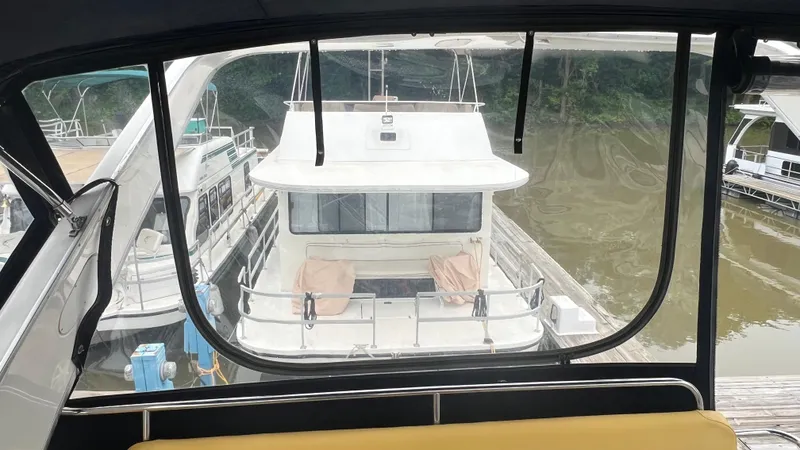  Yacht Photos Pics 1999 Bayliner 3988 Motoryacht docked at marina, viewed from another boat.