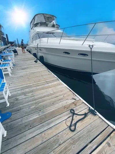  Yacht Photos Pics 2002 Sea Ray 56 Sedan Bridge yacht docked under a bright blue sky.