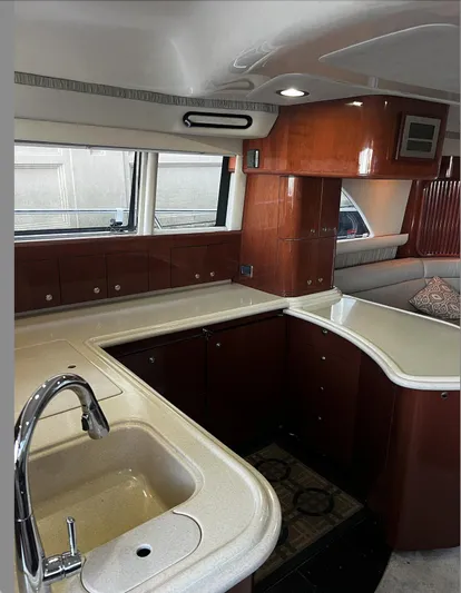  Yacht Photos Pics 2002 Sea Ray 56 Sedan Bridge yacht kitchen with wood cabinetry and modern fixtures.